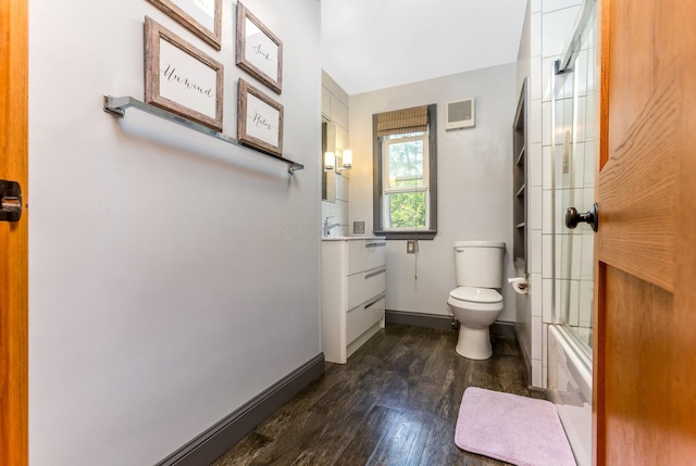 200 Park Ave, New Lexington, OH 43764 - bathroom featuring toilet, wood finished floors, vanity, baseboards, and enclosed tub / shower combo