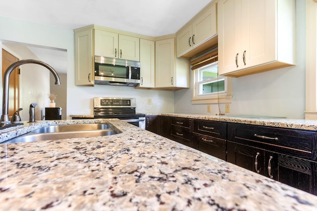 200 Park Ave, New Lexington, OH 43764 - kitchen featuring appliances with stainless steel finishes, a sink, and light stone countertops