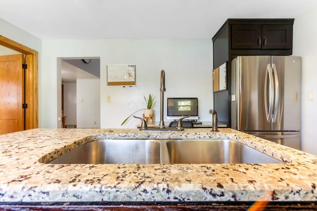200 Park Ave, New Lexington, OH 43764 - kitchen with freestanding refrigerator, light stone counters, and a sink