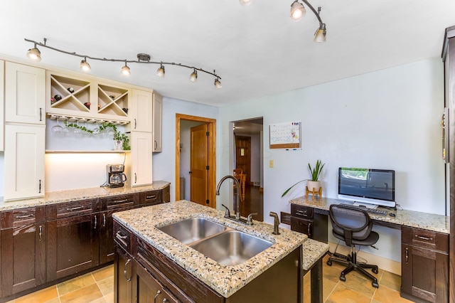 200 Park Ave, New Lexington, OH 43764 - kitchen with a sink, rail lighting, an island with sink, and dark brown cabinets