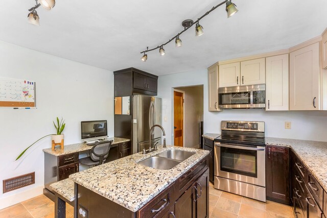 200 Park Ave, New Lexington, OH 43764 - kitchen with stainless steel appliances, a sink, dark brown cabinetry, and light stone counters