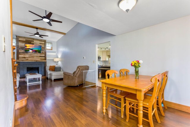 200 Park Ave, New Lexington, OH 43764 - dining space with wood finished floors, ceiling fan, vaulted ceiling, a fireplace, and baseboards