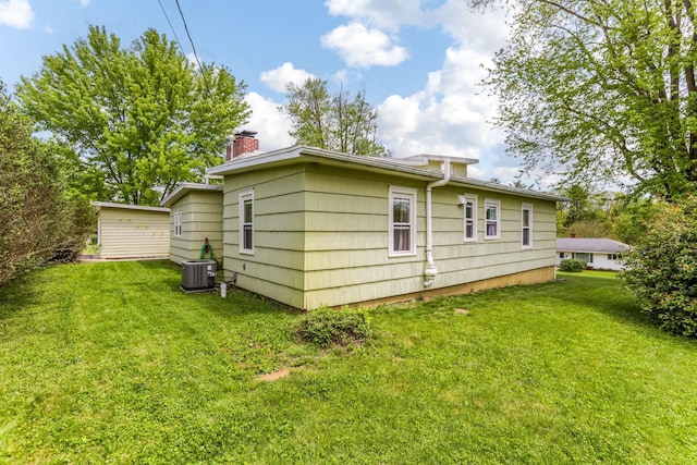 200 Park Ave, New Lexington, OH 43764 - rear view of property with cooling unit, a chimney, and a lawn
