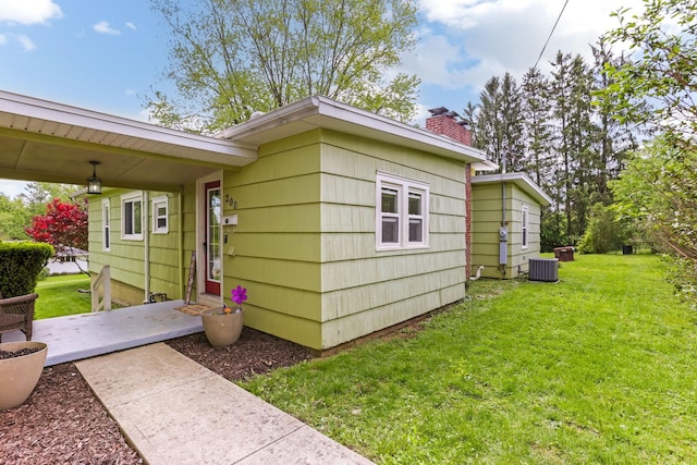 200 Park Ave, New Lexington, OH 43764 - view of side of home featuring a lawn, central AC, and a chimney