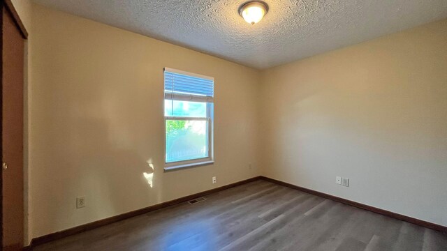 7586 Jenkins Dr, Canal Winchester, OH 43110 - spare room featuring wood finished floors, a textured ceiling, and baseboards