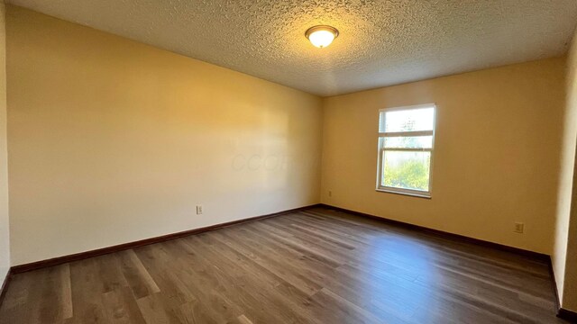 7586 Jenkins Dr, Canal Winchester, OH 43110 - unfurnished room with wood finished floors, baseboards, and a textured ceiling