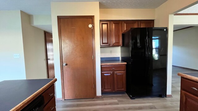 7586 Jenkins Dr, Canal Winchester, OH 43110 - kitchen featuring freestanding refrigerator, dark countertops, and light wood-style flooring
