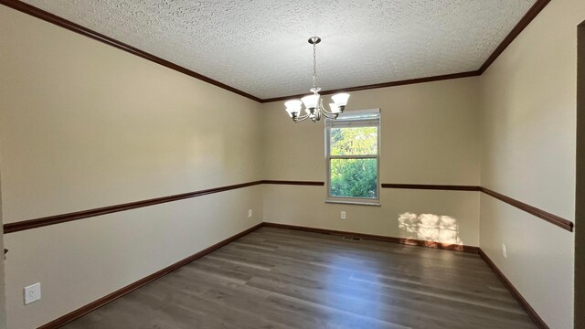 7586 Jenkins Dr, Canal Winchester, OH 43110 - spare room featuring a textured ceiling, wood finished floors, ornamental molding, a chandelier, and baseboards