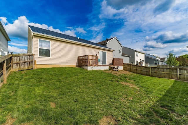 rear view of property featuring a deck