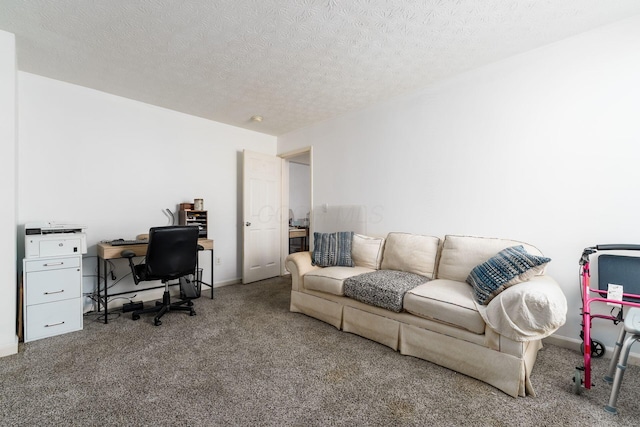 living area featuring carpet flooring, a desk, a textured ceiling, and baseboards