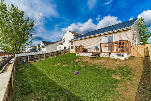back of house featuring a wooden deck and a shingled roof