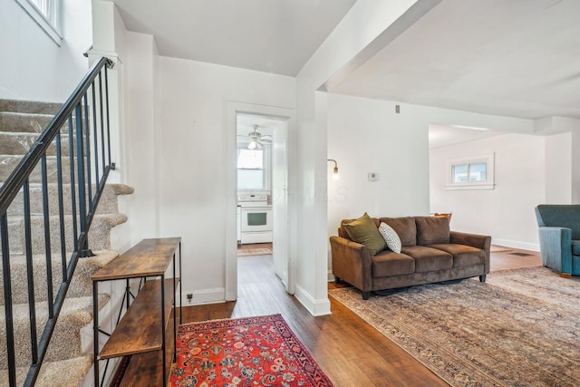 1066 Kelton Ave, Columbus, OH 43206 - living room with stairway, wood finished floors, baseboards, and a ceiling fan