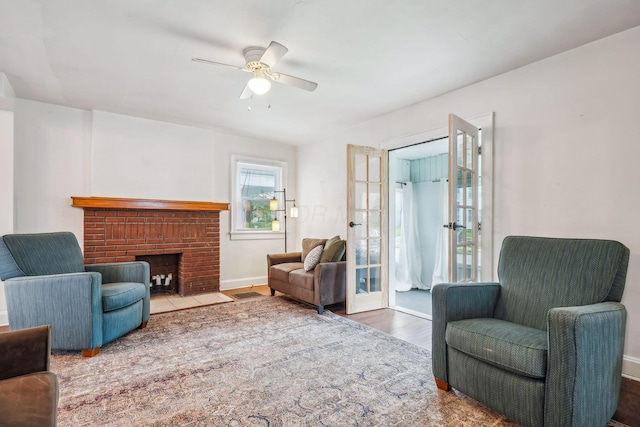 1066 Kelton Ave, Columbus, OH 43206 - living room featuring wood finished floors, a ceiling fan, a fireplace, and baseboards