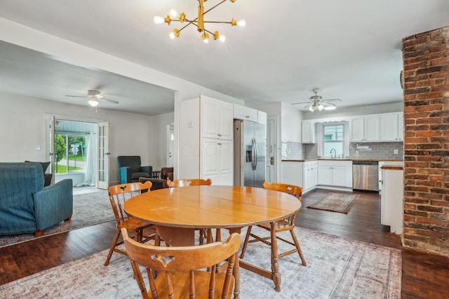 1066 Kelton Ave, Columbus, OH 43206 - dining room with ceiling fan, dark wood-type flooring, and a chandelier