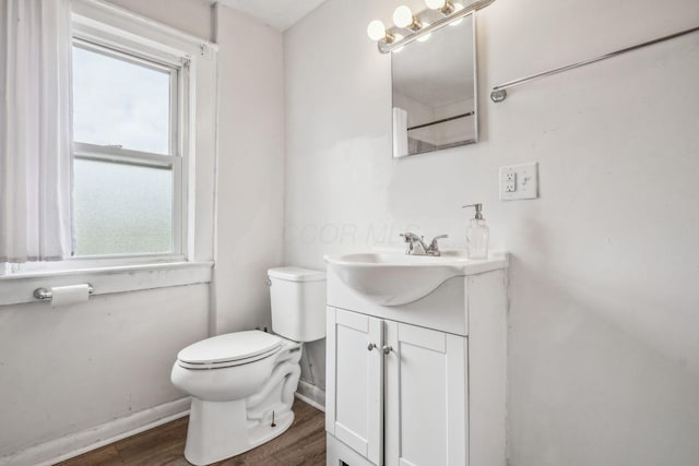 1066 Kelton Ave, Columbus, OH 43206 - bathroom featuring toilet, wood finished floors, healthy amount of natural light, and vanity