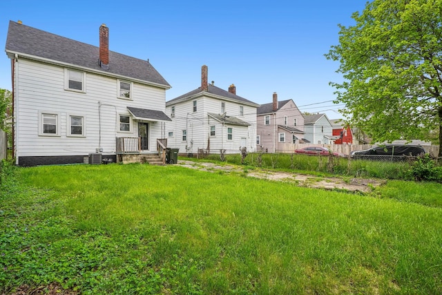 1066 Kelton Ave, Columbus, OH 43206 - rear view of house with fence, central AC, and a chimney