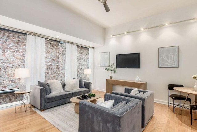 106 N High St Unit 504, Columbus, OH 43215 - living area with light wood-style floors, a ceiling fan, and baseboards