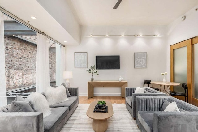 106 N High St Unit 504, Columbus, OH 43215 - living room with wood finished floors, ceiling fan, track lighting, and baseboards