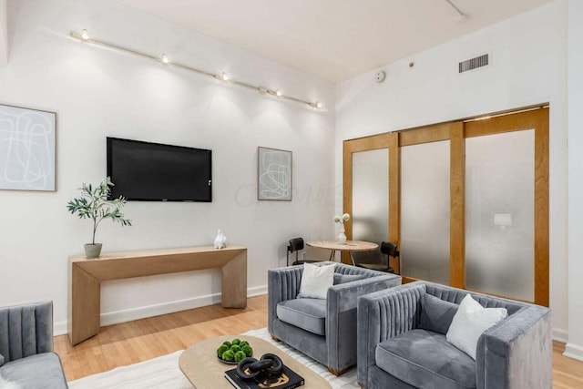 106 N High St Unit 504, Columbus, OH 43215 - living room with rail lighting, wood finished floors, and baseboards