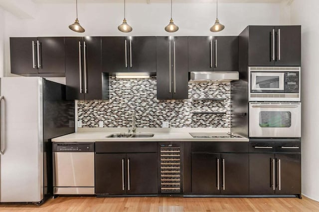 106 N High St Unit 504, Columbus, OH 43215 - kitchen featuring appliances with stainless steel finishes, a sink, light countertops, and decorative light fixtures