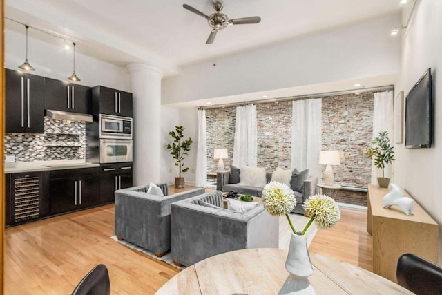 106 N High St Unit 504, Columbus, OH 43215 - living room with light wood-style flooring, beverage cooler, a ceiling fan, and ornate columns