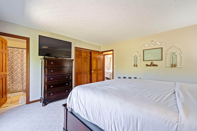 7684 Stout Rd, Circleville, OH 43113 - bedroom with light carpet, a textured ceiling, ensuite bathroom, and baseboards