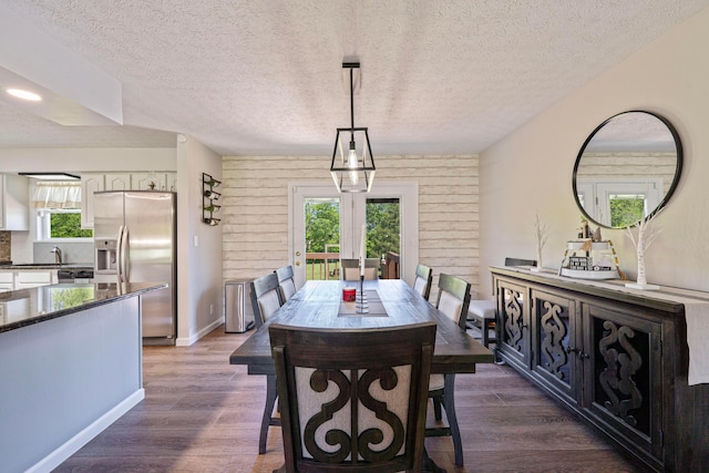 7684 Stout Rd, Circleville, OH 43113 - dining space featuring plenty of natural light, dark wood-style floors, a textured ceiling, and baseboards