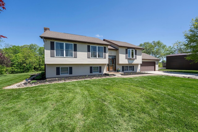 7684 Stout Rd, Circleville, OH 43113 - raised ranch with a chimney, concrete driveway, a garage, and a front yard