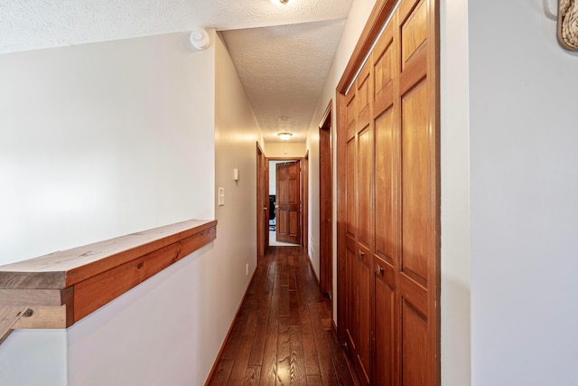 7684 Stout Rd, Circleville, OH 43113 - hallway with a textured ceiling, dark wood-type flooring, and baseboards