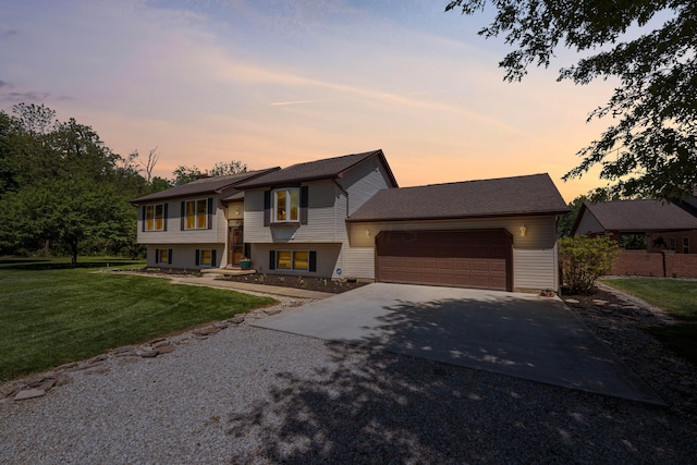 7684 Stout Rd, Circleville, OH 43113 - raised ranch with concrete driveway, a garage, and a lawn