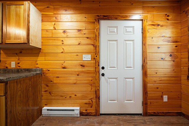 34047 W Buckingham Rd, Logan, OH 43138 - doorway to outside featuring wood walls, dark wood finished floors, and baseboard heating