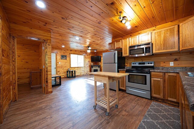 34047 W Buckingham Rd, Logan, OH 43138 - kitchen featuring stainless steel appliances, dark wood-type flooring, wooden walls, dark countertops, and wood ceiling