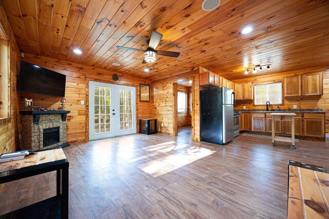 34047 W Buckingham Rd, Logan, OH 43138 - unfurnished living room with wooden ceiling, a ceiling fan, dark wood-type flooring, wooden walls, and a sink