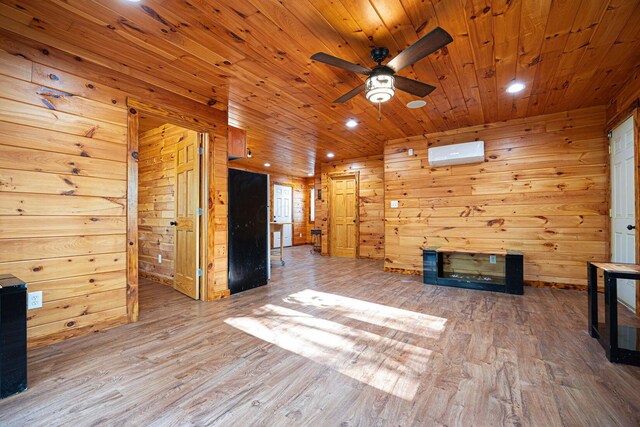 34047 W Buckingham Rd, Logan, OH 43138 - unfurnished living room with wood walls, ceiling fan, an AC wall unit, wood finished floors, and wood ceiling