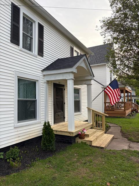 125 College St, Urbana, OH 43078 - back of property featuring a wooden deck and a yard
