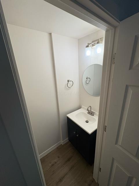 125 College St, Urbana, OH 43078 - bathroom featuring wood finished floors and vanity