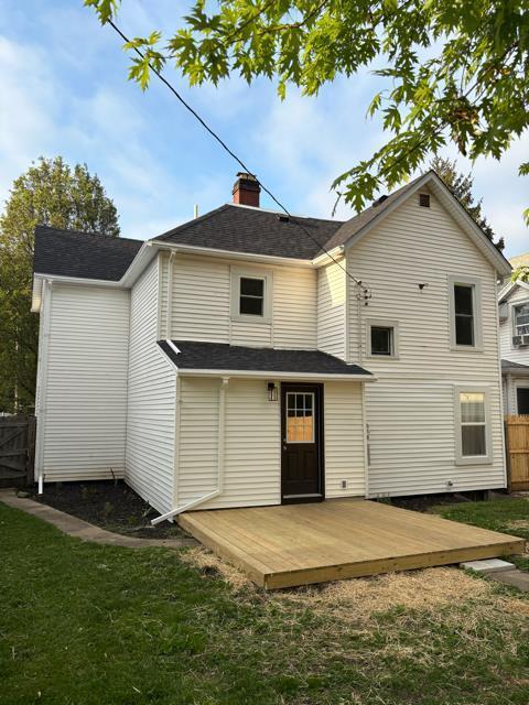 125 College St, Urbana, OH 43078 - back of property featuring a deck and a chimney
