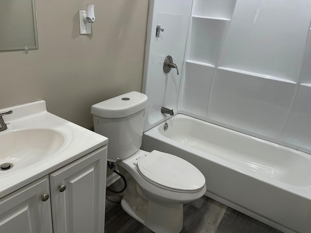 full bathroom with wood finished floors, toilet, vanity, and shower / bath combination