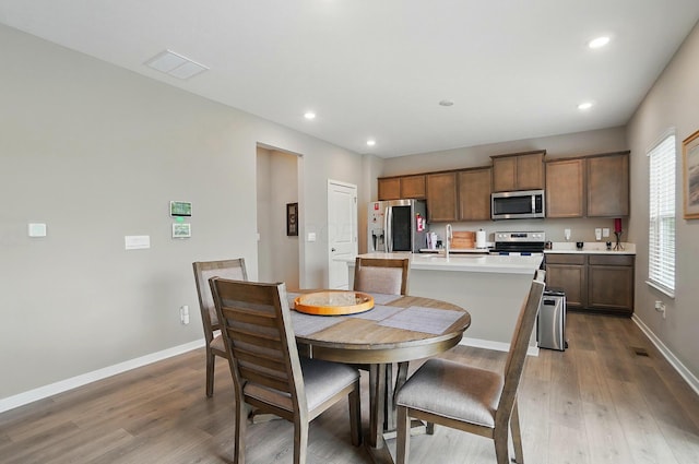 4410 Holstein Dr, Columbus, OH 43207 - dining space featuring wood finished floors, recessed lighting, and baseboards
