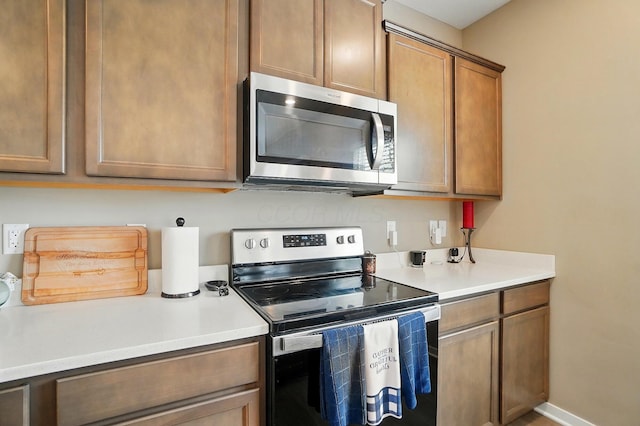 4410 Holstein Dr, Columbus, OH 43207 - kitchen with stainless steel appliances, light countertops, and brown cabinetry