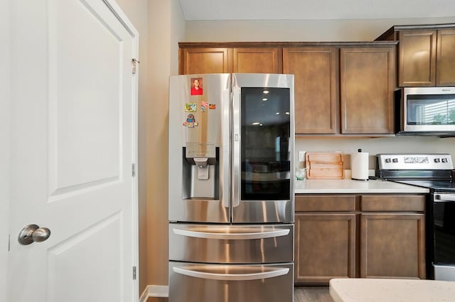 4410 Holstein Dr, Columbus, OH 43207 - kitchen featuring appliances with stainless steel finishes, light countertops, and wood finished floors
