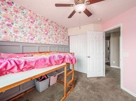 592 Summer Tree Loop, Marysville, OH 43040 - bedroom with wallpapered walls, wainscoting, carpet, a closet, and a ceiling fan
