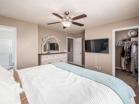 592 Summer Tree Loop, Marysville, OH 43040 - bedroom featuring a closet, a spacious closet, a ceiling fan, wood finished floors, and ensuite bathroom