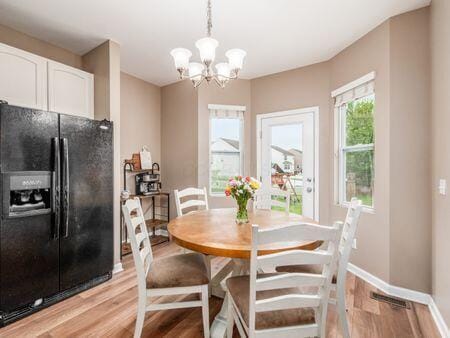 592 Summer Tree Loop, Marysville, OH 43040 - dining space featuring light wood-type flooring, baseboards, and a chandelier