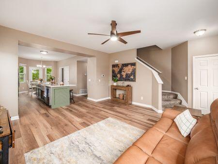 592 Summer Tree Loop, Marysville, OH 43040 - living area with ceiling fan, light wood finished floors, stairway, and baseboards