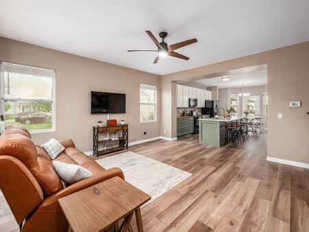 592 Summer Tree Loop, Marysville, OH 43040 - living room featuring ceiling fan, light wood-style floors, and baseboards