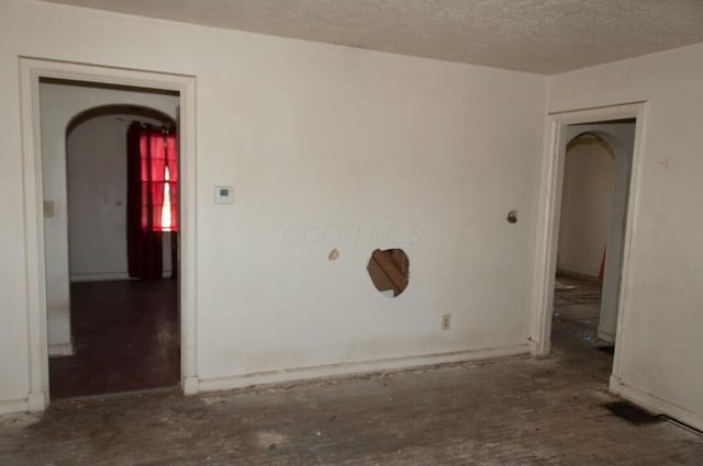 1275 Briarwood Ave, Columbus, OH 43211 - empty room with a textured ceiling and arched walkways