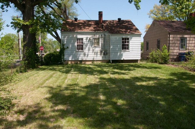1275 Briarwood Ave, Columbus, OH 43211 - back of house featuring a lawn and a chimney