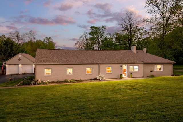 5927 Taylor Rd, Gahanna, OH 43230 - view of front of home featuring a chimney, a garage, a yard, an outbuilding, and asphalt driveway