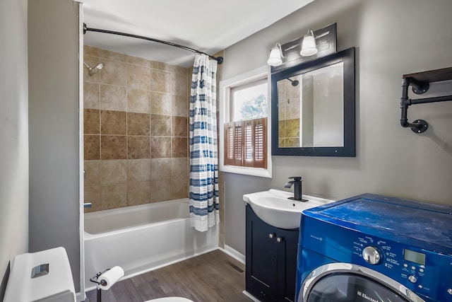 229 Pennsylvania Ave, Marion, OH 43302 - full bathroom with washer / dryer, shower / bath combo with shower curtain, wood finished floors, vanity, and baseboards